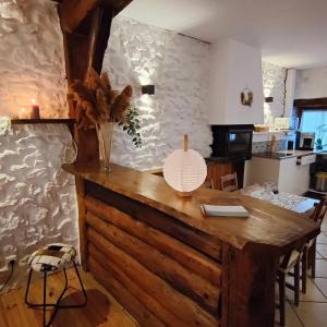 a table with a lamp on top of it in a kitchen at La Monta Cosy in Saint-Égrève