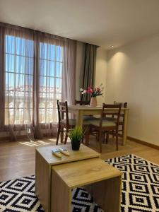 a living room with a table and chairs and a dining room at One bedroom old town tawaya Sahel hashish in Hurghada