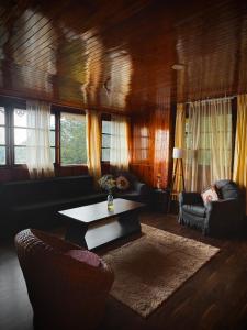 a living room with a table and a couch at ukiyo homes in Darjeeling