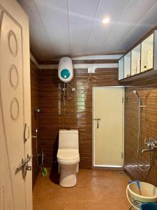 a small bathroom with a toilet and a shower at ukiyo homes in Darjeeling