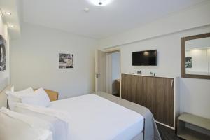 a hotel room with a bed and a tv at Potaissa Hotel in Turda