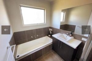 a bathroom with a bath tub and a sink at Constance Retreat - Wifi, Netflix in Venus Bay +8 photos