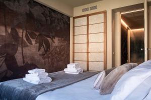 a pile of towels sitting on top of a bed at Casa Abelia - Boutique Apartment in Venice