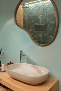 a bathroom sink with a large mirror on a counter at Casa Abelia - Boutique Apartment in Venice +17 photos