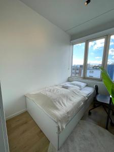 コペンハーゲンにあるNorrebro big aptの白いベッドルーム(ベッド1台、デスク、窓付)