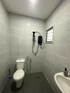 a bathroom with a toilet and a shower at RJ Homestay Kuala Krai-PRIVATE POOL in Kuala Kerai