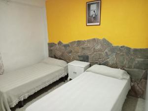 Postel nebo postele na pokoji v ubytování El Almendro de la Tia Teresa + 9 fotografií