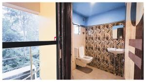 a bathroom with a toilet and a sink at স্বস্তিকা Swash-Tikaa Digha Near Sea Beach AC Or Non AC Room in Digha +34 photos