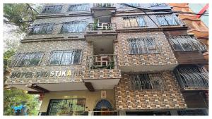 a tall brick building with bars on the windows at স্বস্তিকা Swash-Tikaa Digha Near Sea Beach AC Or Non AC Room in Digha