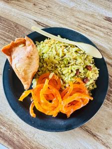 a blue plate of food with vegetables and rice at Hotel Balaji Inn, Ayodhya Bypass in Bhopal