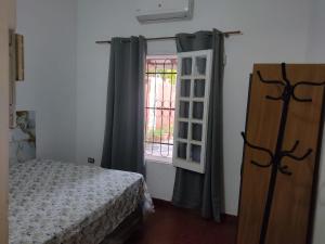 a bedroom with a bed and a window at Miraflores 2- Calor de Hogar in Asuncion
