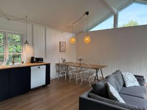 a living room with a couch and a table at Vacation home 1 minute away from the Beach in Yderby