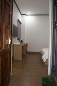 a room with a bedroom with a bed and a television at Hotel88 in Ấp Bình Hưng