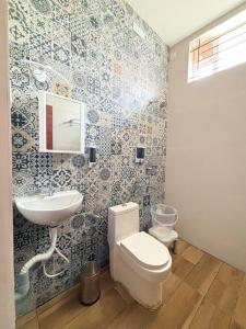 a bathroom with a toilet and a sink at WOW Naturefull Resorts in Yercaud