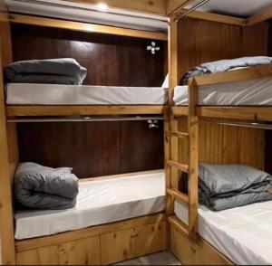 a room with three bunk beds on a boat at Hotel Krishna in Rishīkesh