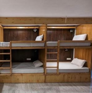 a group of bunk beds in a room at Hotel Krishna in Rishīkesh