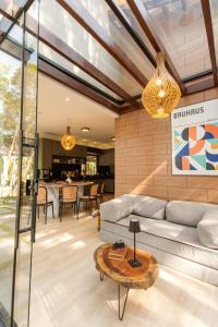 a living room with a couch and a table at Vila Topo do Mundo in Inhussu +21 photos