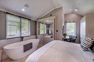a large bathroom with a large tub and a shower at Landal Bryn Morfydd in Llanrhaiadr