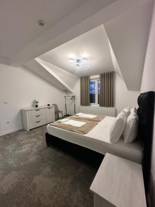 a bedroom with a large bed and a window at Vila Aleksandar in Orašac