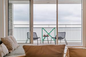 a living room with two chairs and a table at Hello Zeeland - Appartment Port Scaldis 07-031 in Breskens