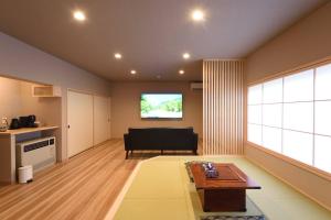 a living room with a couch and a table at The,おこもりの宿 夢流し in Takayama