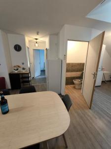 a room with a table and a kitchen and a bathroom at L'étoile de rocroy in Rocroi +3 photos