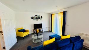 a living room with a blue couch and yellow chairs at Spacious Ground Floor 2-Bed Flat - Patio, Parking - By Habitats in Southampton