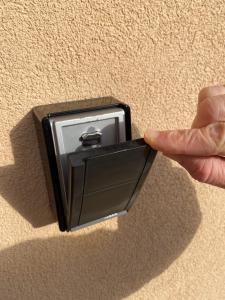 a person is holding a lightswitch in a socket at Budapest Airport Accomodation in V3 in Vecsés
