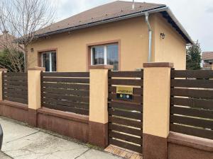 a house with a fence with a sign on it at Budapest Airport Accomodation in V3 in Vecsés