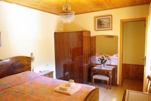 una camera con letto, tavolo e scrivania di Casettina delle Dolomiti a Mezzano