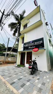 a scooter parked in front of a building at Rams Guest House Meadows Walk to Varkala Papnasam Beach - Groups & Couple friendly in Varkala