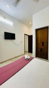 a room with a yoga mat and two pairs of shoes at Rams Guest House Meadows Walk to Varkala Papnasam Beach - Groups & Couple friendly in Varkala