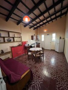 Una sala de estar con una mesa y una cocina. en BERIMI Hospedaje familiar, en Cerrillos