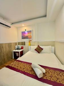 a bedroom with a large white bed with two pillows at Hotel Minh Hang in Phan Thiet +79 photos