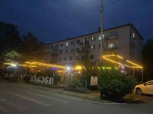 a building with lights on the side of a street at Ruslan Hootel 3 in Poti +2 photos