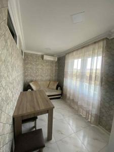 a living room with a couch and a table at Ruslan Hootel 3 in Poti