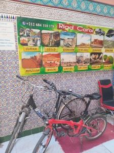 a bike parked in front of a wall with posters at Riad Carole - Perfect for Families & Groups in Marrakesh