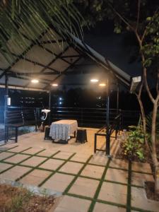a table and chairs under a tent at night at Flumen Resort in Ernakulam