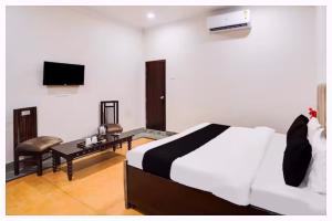 a hotel room with a bed and a television at Hotel Ashirvad Inn Residency Near Lakshmi Temple in Shirdi