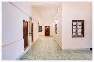 an empty hallway with white walls and a door at Hotel Ashirvad Inn Residency Near Lakshmi Temple in Shirdi