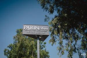 a sign for a hotel and restaurant on a pole at Parin Azure Hotels & Resorts in Amritsar +1 photo