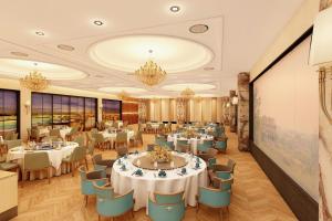 a banquet hall with tables and chairs and a wall at Parin Azure Hotels & Resorts in Amritsar