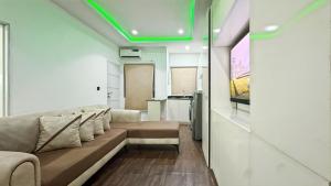 a living room with a couch and a kitchen at Aradu Apartment in Abuja