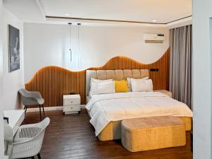 a bedroom with a large bed with a wooden headboard at Aradu Apartment in Abuja +11 photos