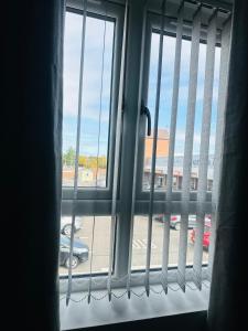 a window with a view of a parking lot at Burton Urban Apartment in Burton upon Trent