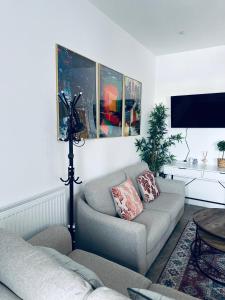 a living room with two couches and a tv at Burton Urban Apartment in Burton upon Trent