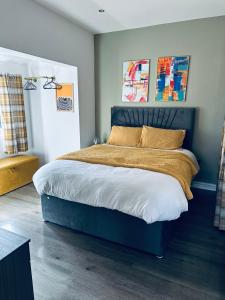 a bedroom with a large bed with a blue headboard at Burton Urban Apartment in Burton upon Trent +39 photos