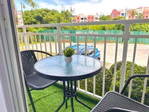 a table and chairs on a balcony with a table at 128A Condotel Near Airport in Lapu Lapu City