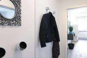 a black jacket hanging on a door with a mirror at Villa Wiederkehr Einkehr in Ostseebad Sellin +11 photos