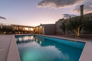 a swimming pool in the backyard of a house at Villa Petar ZadarVillas in Donji Kašić